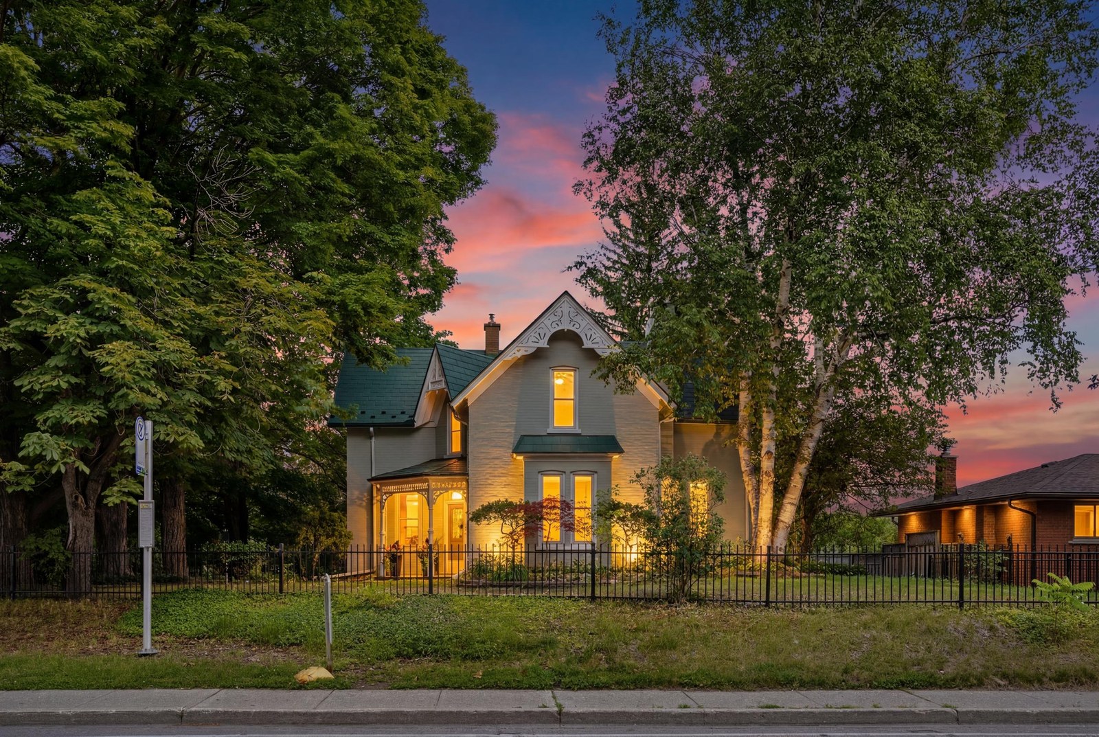 1691 Franklin Boulevard, Cambridge — Gothic Revival heritage home at dusk with pink sunset sky