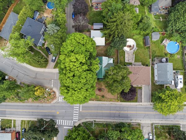 Aerial drone view of the property showing mature trees and lot