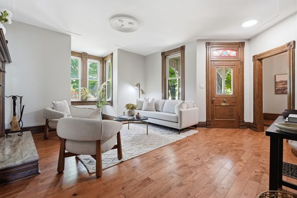 Bright formal front living room with stained glass entry door
