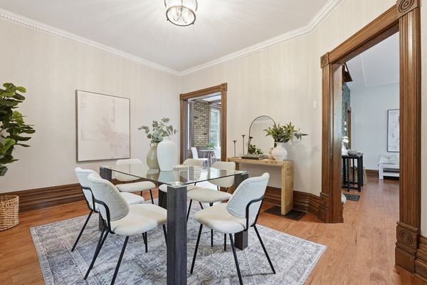 Formal dining room with glass table and dentil crown molding
