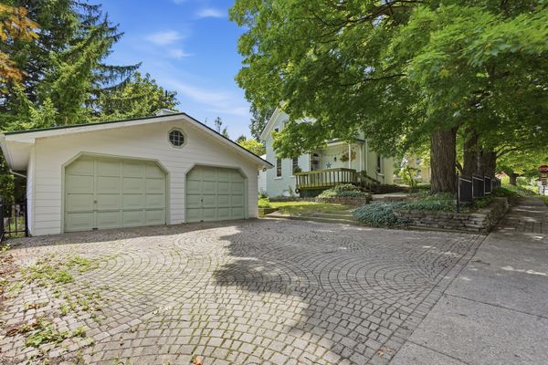 Detached oversized double-car garage with mint green doors